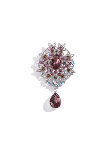 Detailed view of vintage brooch with purple teardrop gemstones and colorful crystals