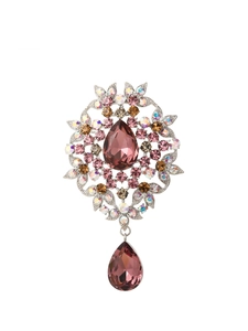Detailed view of a vintage floral brooch featuring pink and purple crystals and teardrop pendants