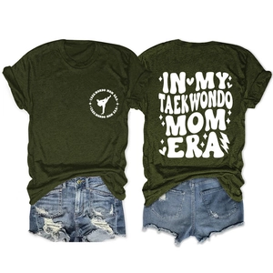 Front and back view of dark green Taekwondo Mom Era graphic T-shirt with denim shorts