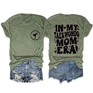 Detailed flat lay of olive green cotton T-shirt with Taekwondo Mom Era printed text