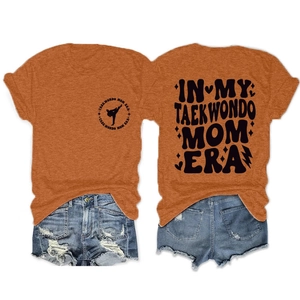 Front and back view of caramel Taekwondo Mom Era graphic T-shirt with denim shorts