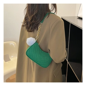 Sac hobo vert avec surpiqûres en V, chaîne dorée et pendentif pompon en peluche blanc