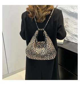 Detail of trendy leopard print large tote bag on model back in minimalist setting