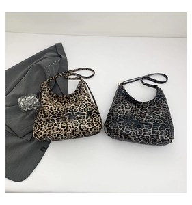 Detailed comparison of brown and dark grey leopard print shoulder bags in crescent shape