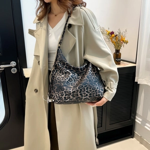 Large leopard print tote bag for women shown with beige trench coat in a modern setting