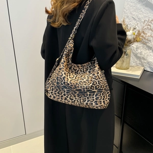 Chic leopard print large tote bag for women worn over the shoulder as a stylish accessory