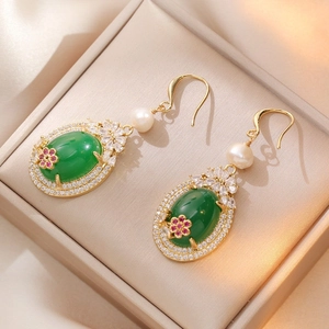 Vintage gold drop earrings with emerald stone, pink flower detail, and natural pearl