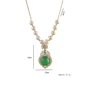 Elegant gold titanium necklace with emerald zircon and fresh water pearls on white background