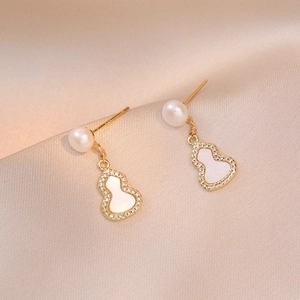 Elegant gold gourd earrings with freshwater pearls and micro-pave zircons on satin
