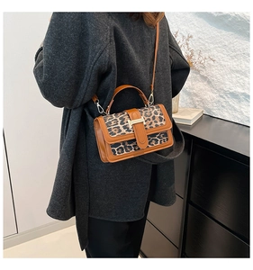 Detail view of the leopard print crossbody bag with iconic H-shaped metal buckle