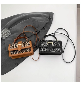 Detail of vintage leopard print crossbody bags with gold buckles and leather handles