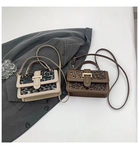 Detail of vintage leopard print square handbags in cream and brown with gold hardware