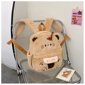 Detail eines flauschigen Bärenrucksacks mit süßer Stickerei und gepunktetem Minihut-Dekor