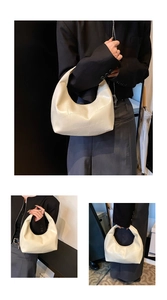 Detail of beige hobo bag showing unique geometric stitching and versatile handle design