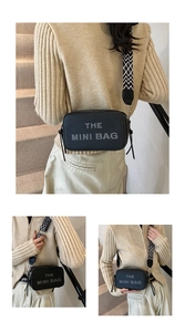Close-up of black lychee grain mini bag with a geometric pattern wide shoulder strap