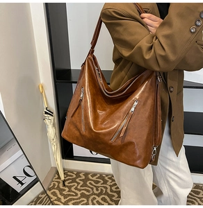 Détail du grand sac à épaule vintage marron avec double fermeture éclair et aspect cuir