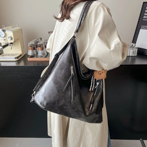 Retro black faux leather large capacity tote bag with bear charm shown on a model
