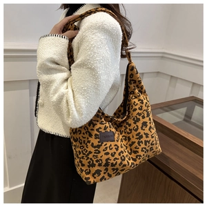 Close-up of leopard print corduroy tote bag with black fashion label and large capacity