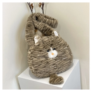 Close-up of cat-shaped plush crossbody bag with blue sapphire eyes and soft faux fur