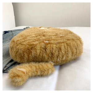 Detailed view of the plush orange tabby cat bag featuring a soft 3D furry tail