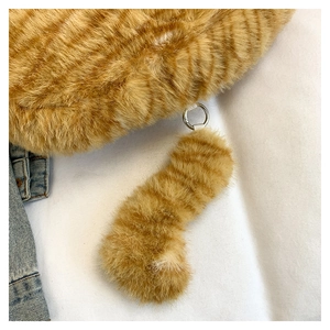 Detail of soft orange striped faux fur bag with a premium metal ring buckle attachment
