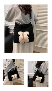 Detail view of large black corduroy tote bag with plush animal patch and drawstring closure