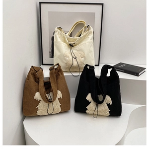 Three corduroy tote bags with cute dog patches in beige, brown, and black colors