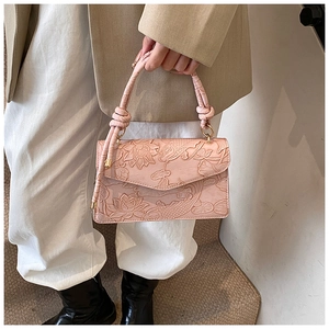 Pink top handle bag with lotus and koi embossed patterns and gold ring hardware