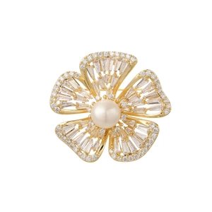 Close-up of a floral brooch featuring a white pearl center and shimmering zircons