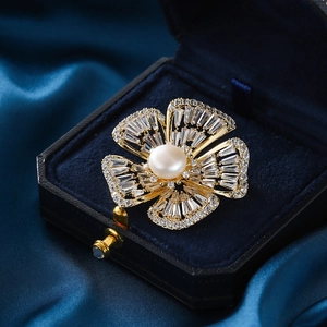Elegant gold flower brooch with freshwater pearl and sparkling cubic zirconia stones