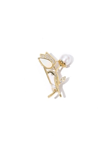 Detailed view of a golden tulip brooch featuring elegant pearls and sparkling zircon accents