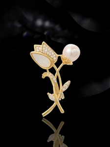 Detailed view of tulip brooch with white pearl, shell petals, and sparkling zirconia