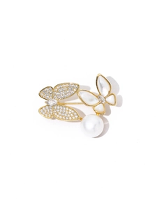Detailed view of butterfly brooch with zircon wings, shell inlay and a pearl drop