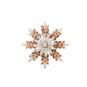 Detailed close-up of a snowflake brooch with multicolor zircons and gold metal base