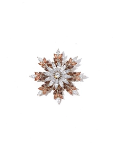 Detailed view of snowflake brooch featuring multi-layered amber and clear crystals