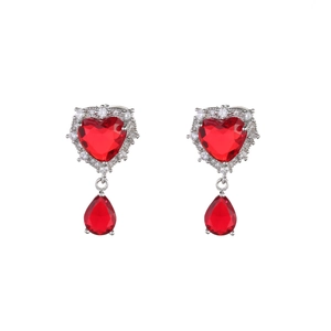 Detail of silver drop earrings featuring red heart zircons and teardrop-shaped red stones