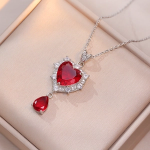 Elegant heart-shaped red zircon pendant necklace set with silver chain and white accents