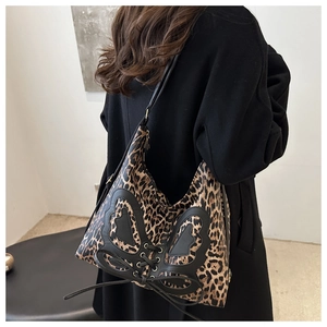 French leopard print tote bag with black butterfly bow and long straps shown on model