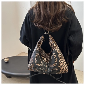 Detailed back view of a large leopard print canvas tote bag with a black leather butterfly motif