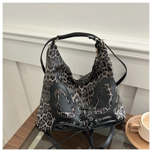 Close-up of leopard print bag with butterfly leather patch and lace-up ribbon details