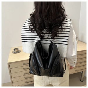 Minimalist black soft leather backpack for women with large capacity and stylish design