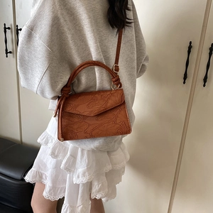 Brown faux leather shoulder bag with lotus embossing and top handle for women