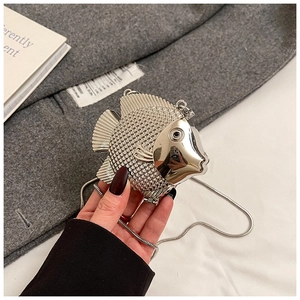 Close-up of silver fish-shaped mini bag showing scale texture and metallic chain