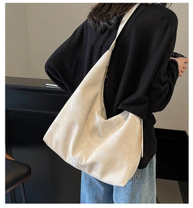 Minimalist creamy white large tote bag with textured faux leather and wide shoulder strap