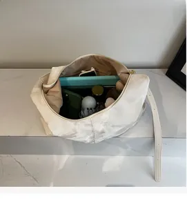 Top view of white tote bag showing large interior space with umbrella and tablet