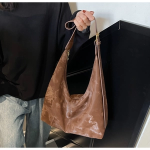 Detail of dark brown marble texture on a large hobo tote bag with adjustable strap