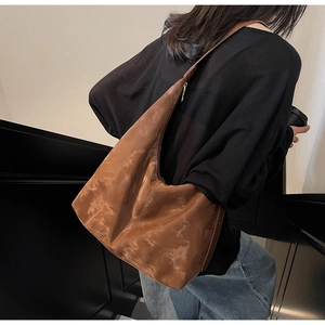 Brown tote bag with marble texture texture shown in a lifestyle urban setting