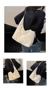 Detail view of large cream hobo bag with marble texture and wide shoulder strap