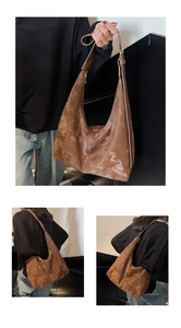 Detailed view of the vintage brown hobo bag showing oily leather texture and adjustable strap