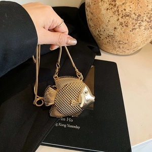 Mini fish-shaped gold metal evening bag with carved scale texture and detachable chain